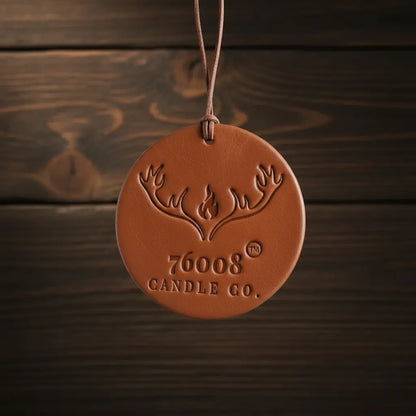 Leather air freshener on dark wood