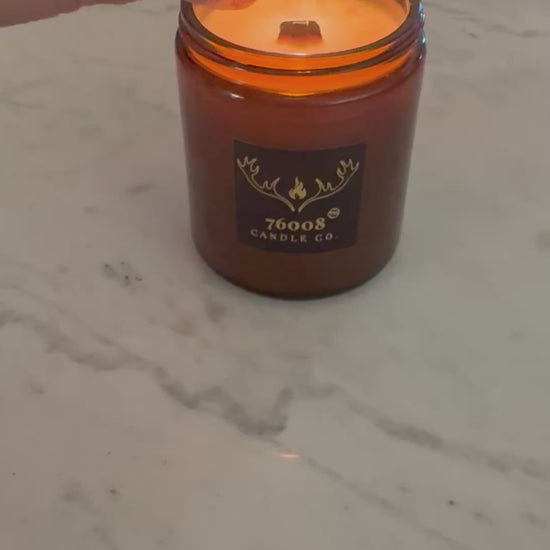 lighting a wood wick candle

